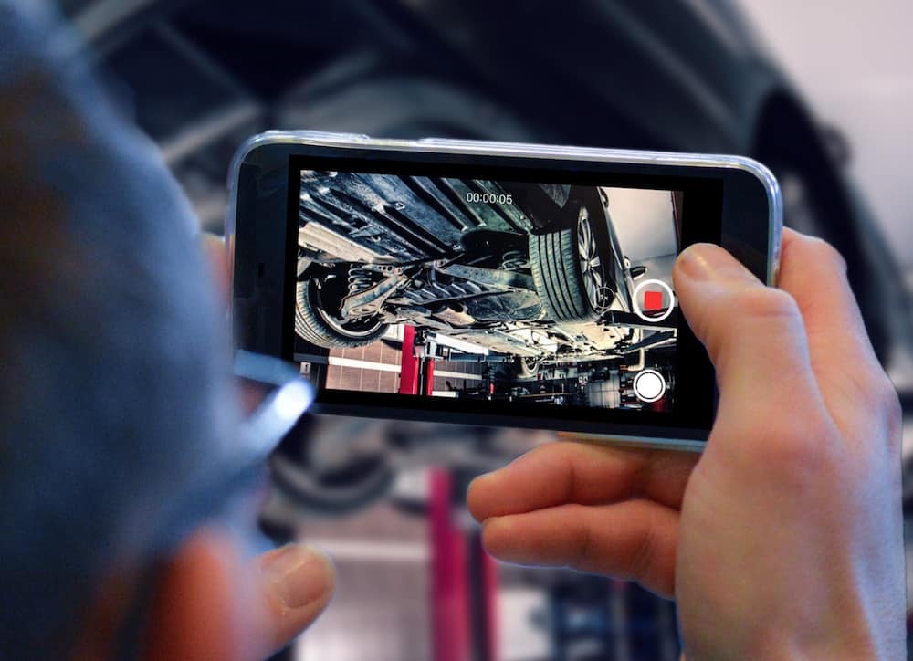 A car mechanic records a video of an SUV using TruVideo.